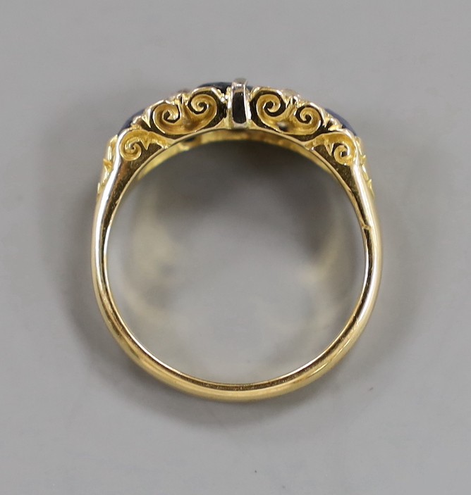 A late Victorian 18ct gold, three stone sapphire, and four stone diamond set half hoop ring, with carved setting, size O, gross weight 4.3 grams.